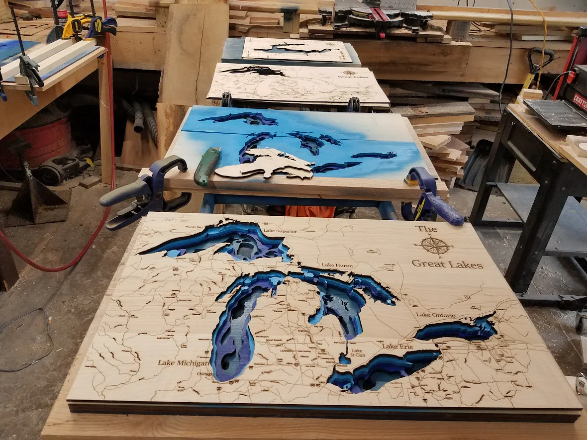 Members using an industrial laser cutter for DIY laser cutting projects